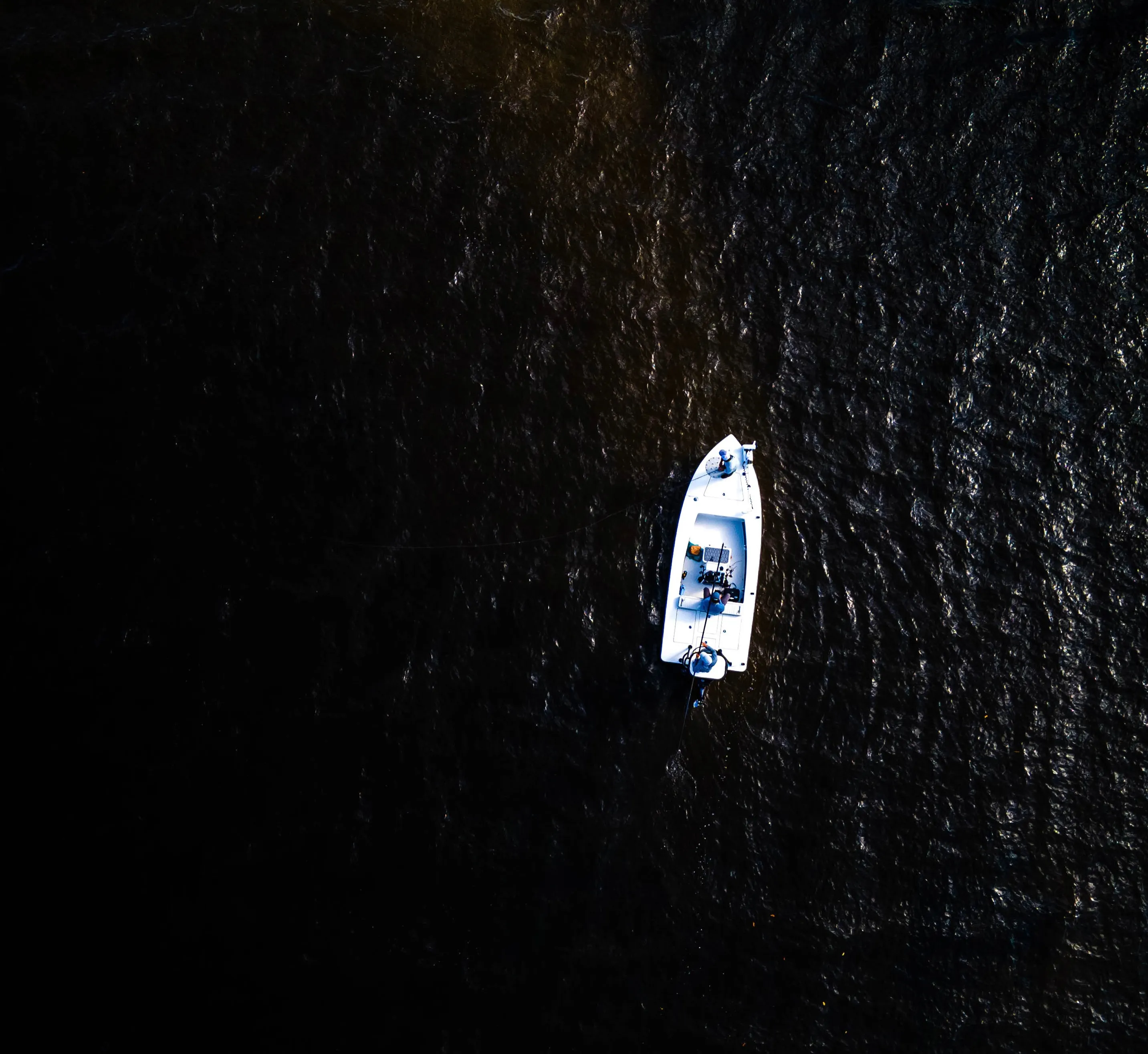 Drone view of a lone skiff on dark, still water at the Indian River Lagoon