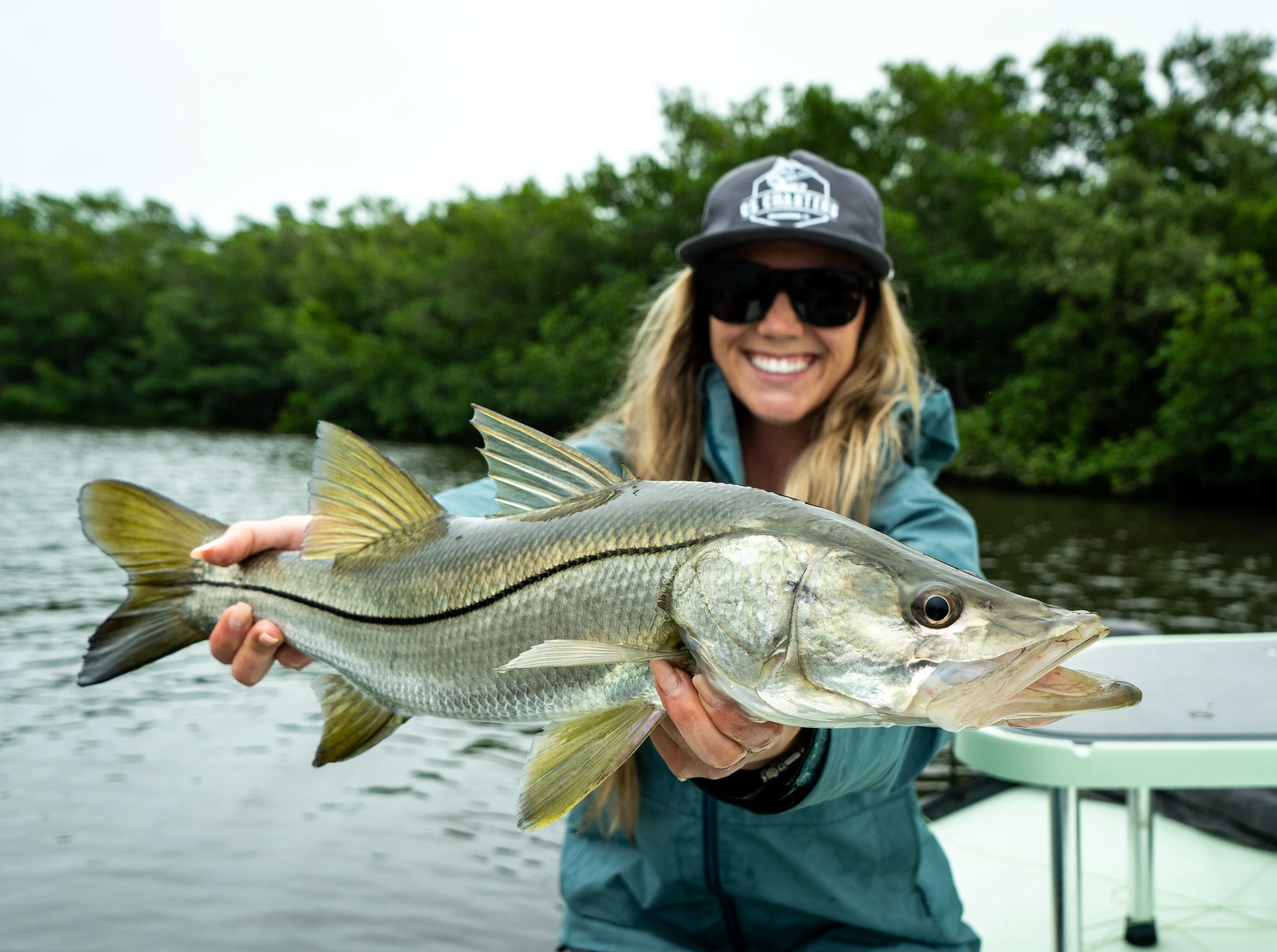 Client holding a snook boatside