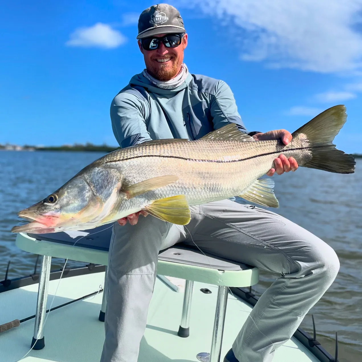 Client holding a large snook boatside