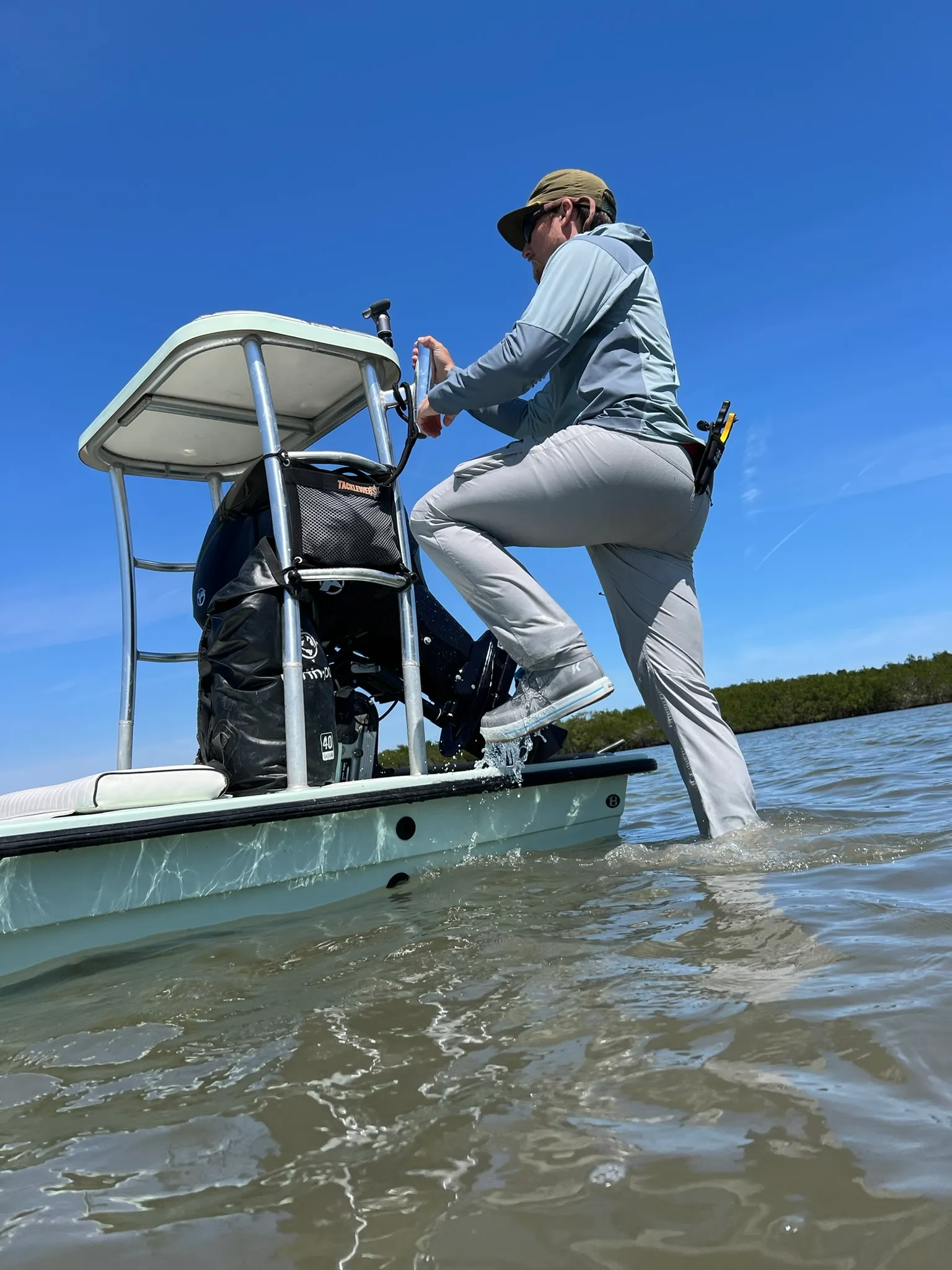 Stepping off the skiff onto a shallow flat