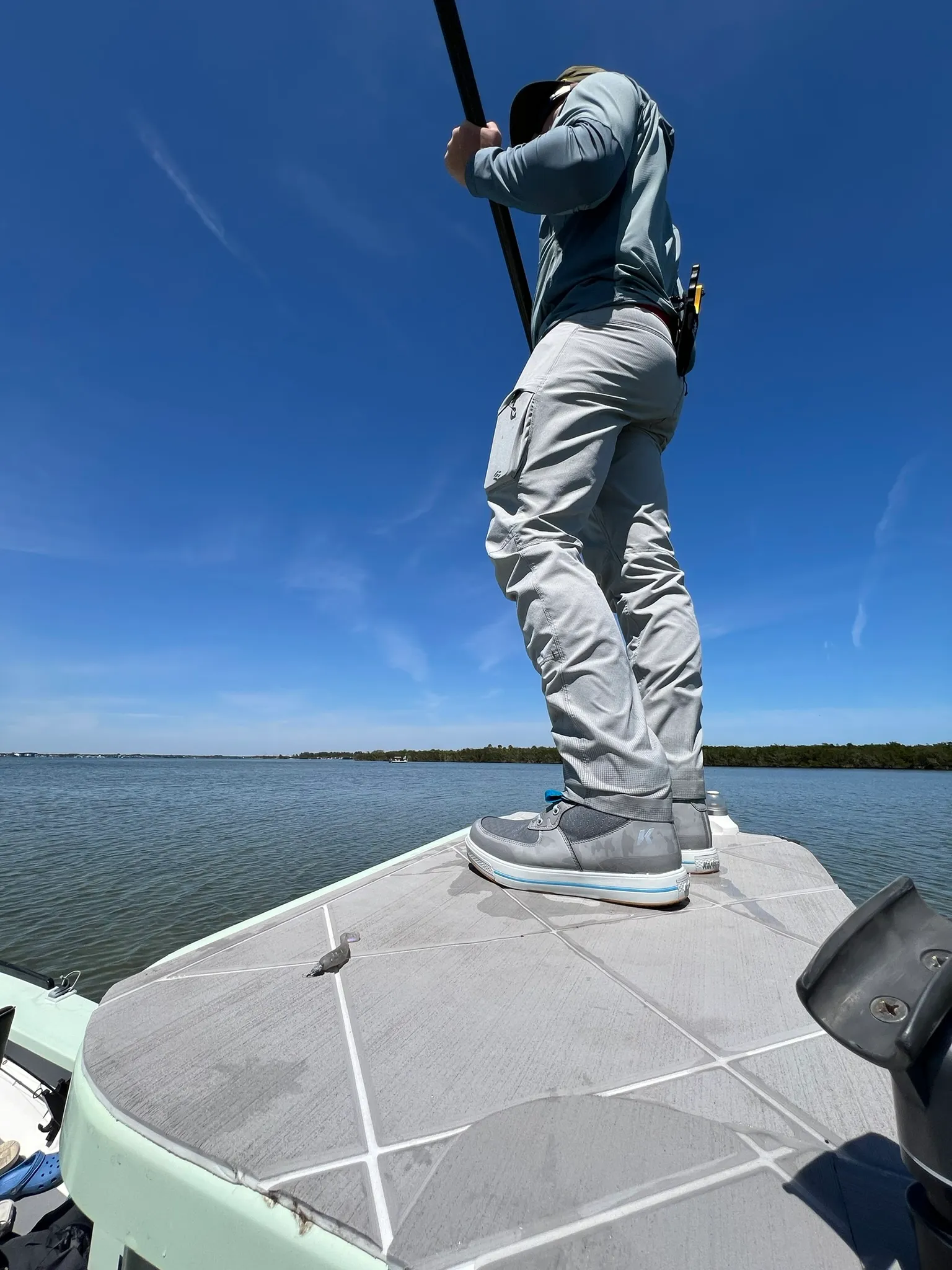 Poling the skiff, low angle from the deck